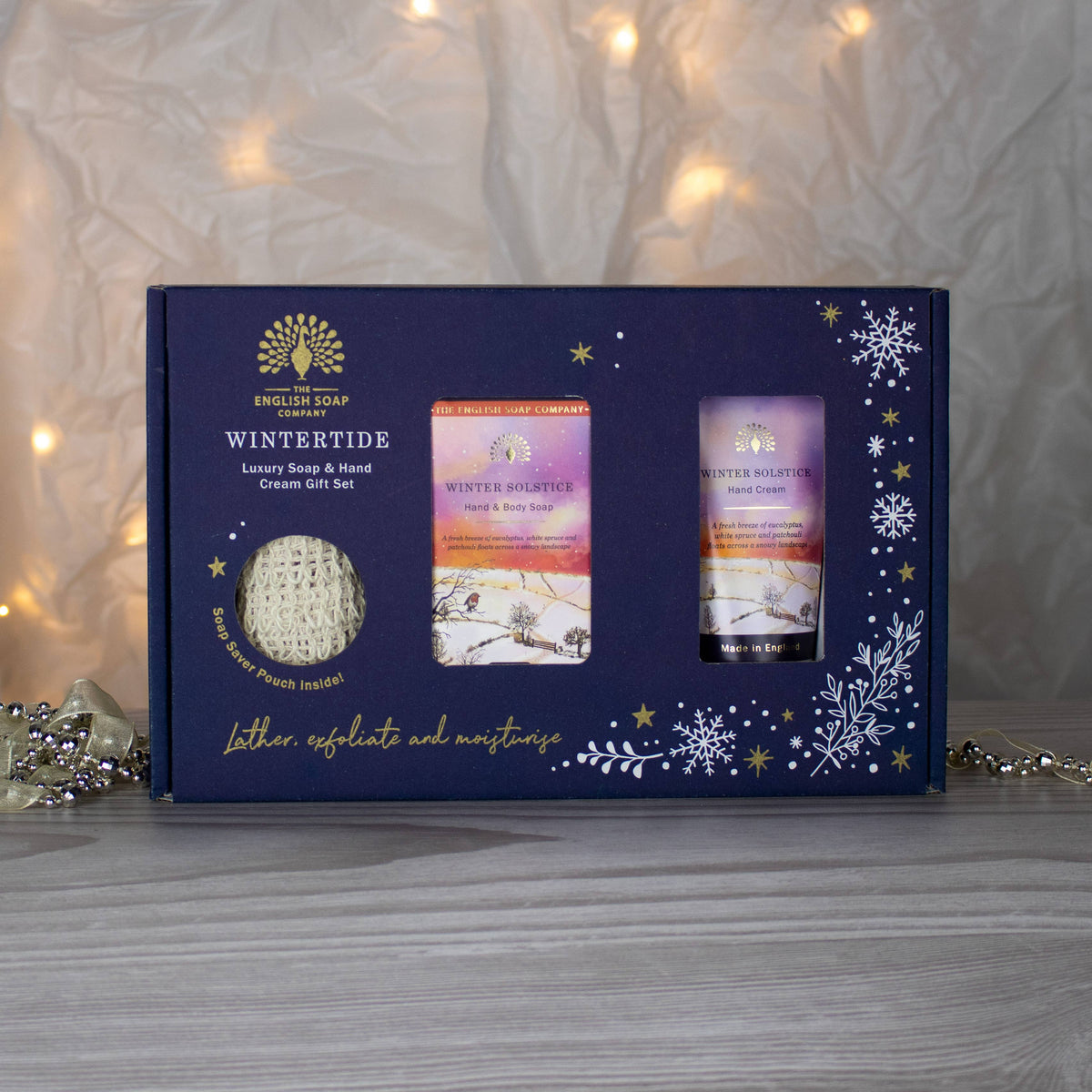 Wintertide gift box in front of fairy lights