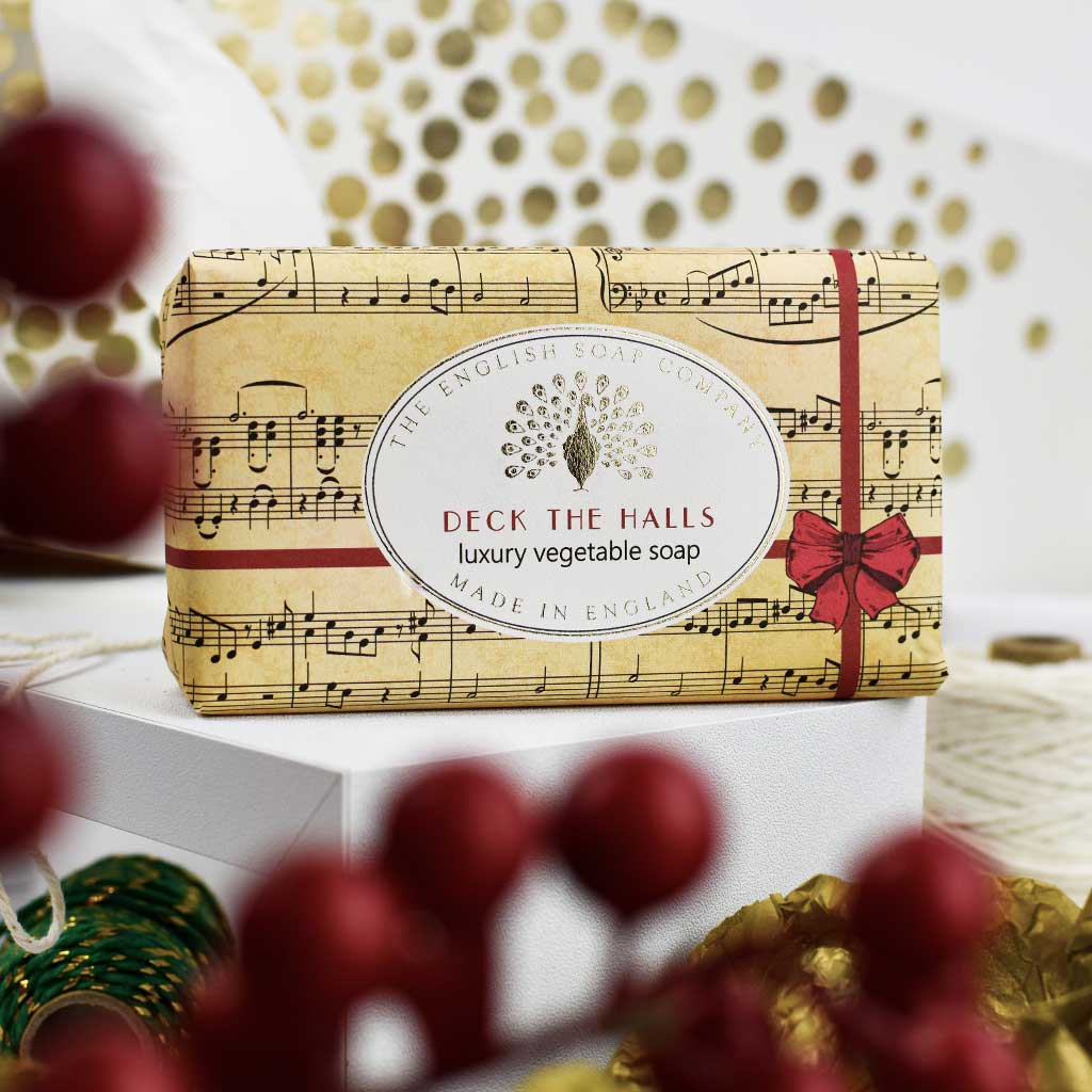 Deck the Halls soap bar among red baubles and string