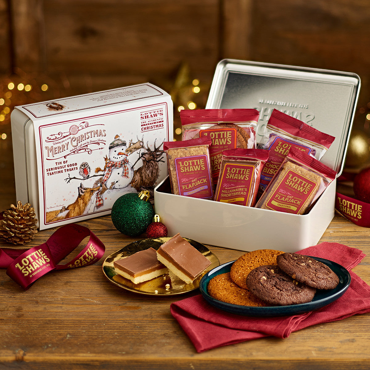 Embossed Lottie Shaw's keepsake tin with a snowman sleeve