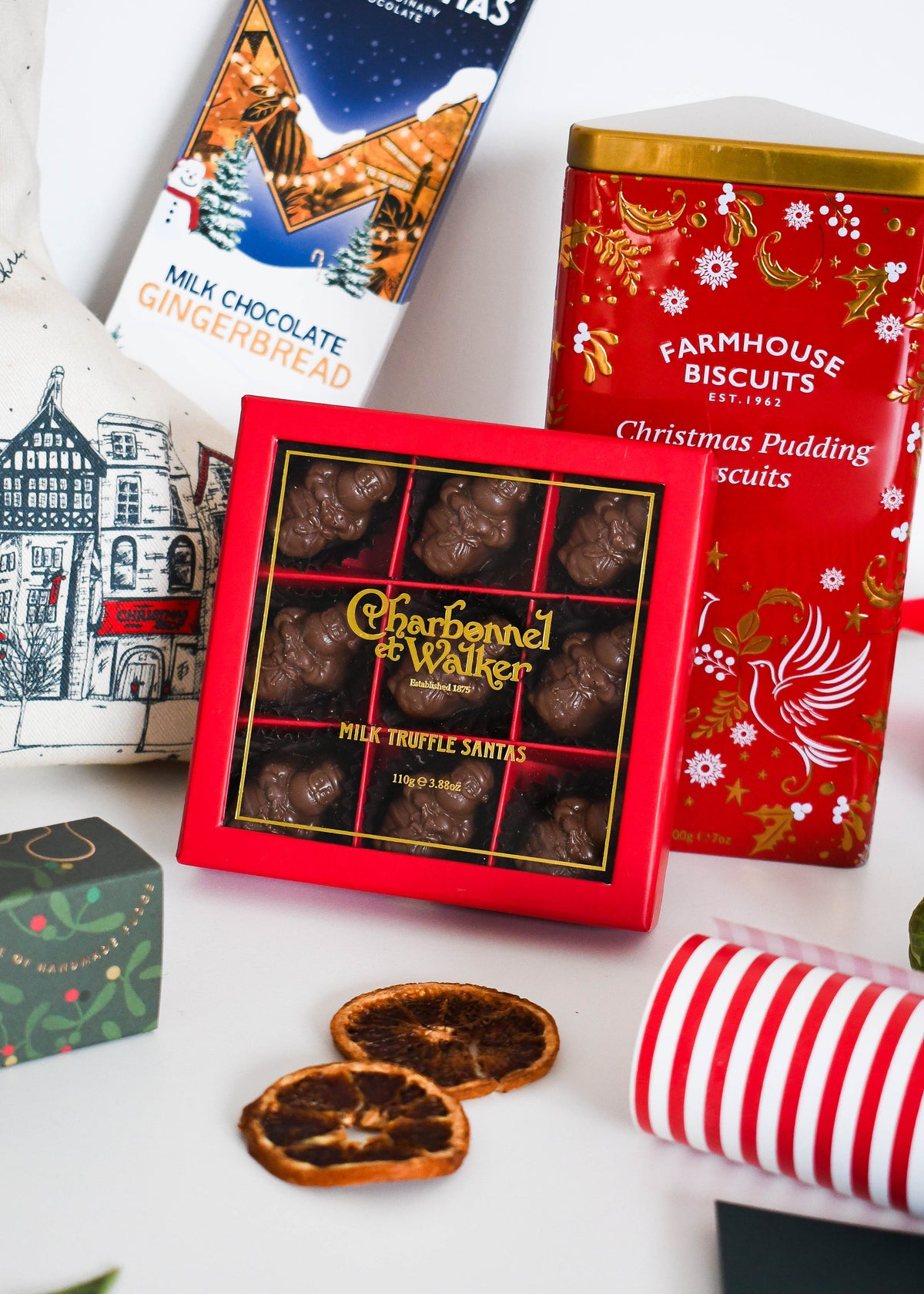 Charbonnel et Walker Milk Truffle Santas with Montezuma's Gingerbread bar and the Farmhouse Biscuits Christmas Pudding tin