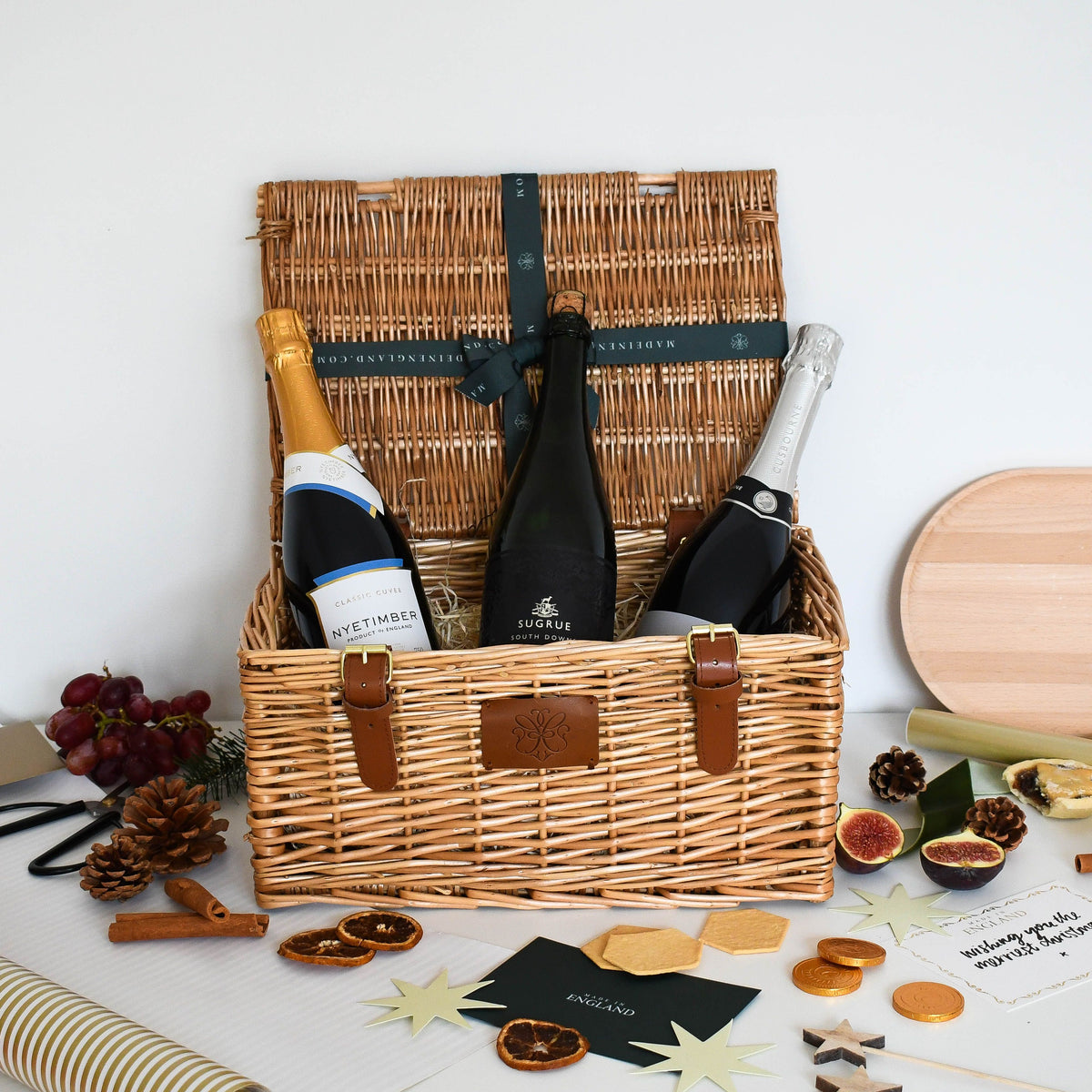 The English Sparkling Wine Trio hamper with bottles from Nyetimber, Sugrue South Downs and Gusbourne in a wicker basket