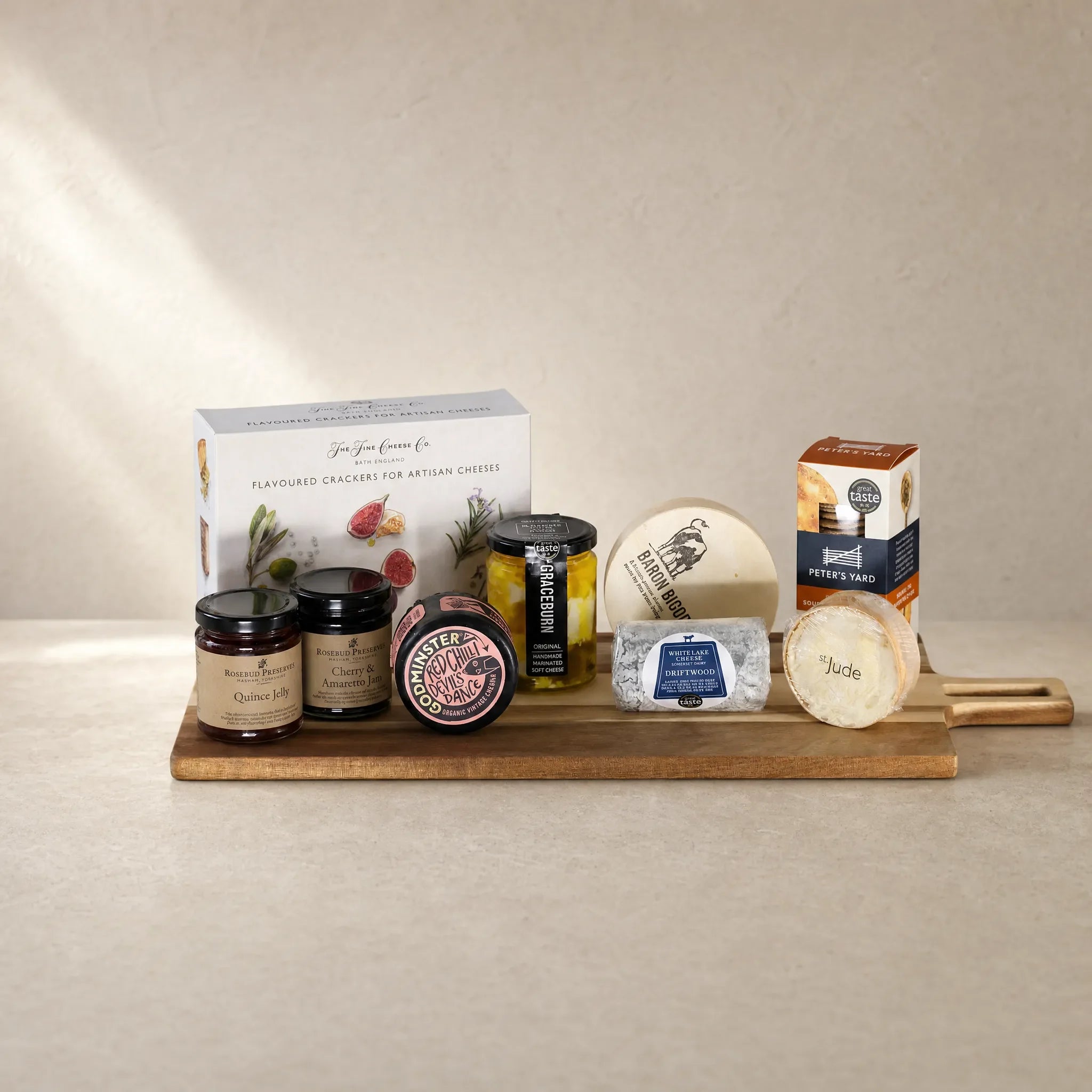 The English Cheeseboard — cheeses, preserves and crackers on a wooden serving board