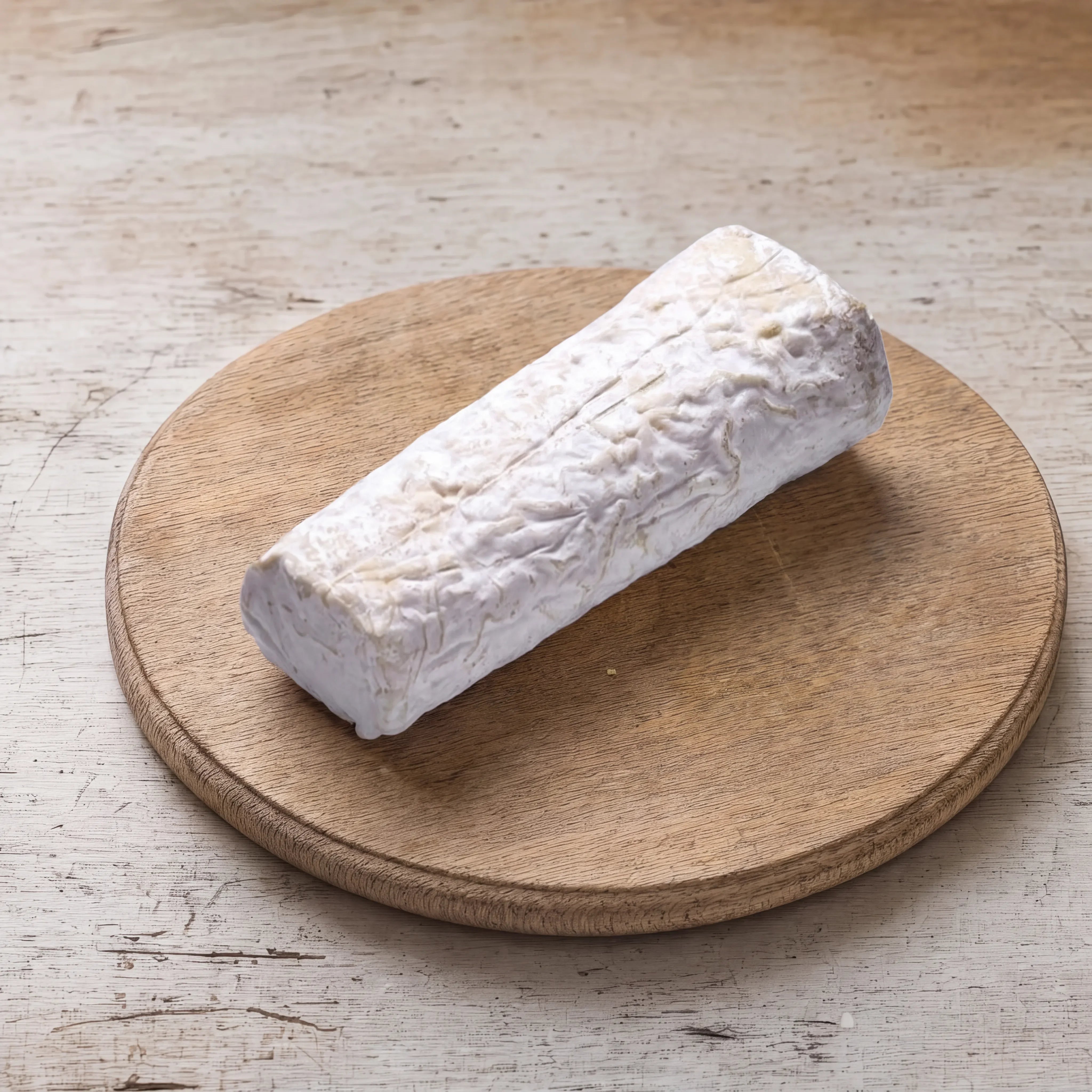 Ragstone goats' cheese log on an oak board, English cheesemonger counter