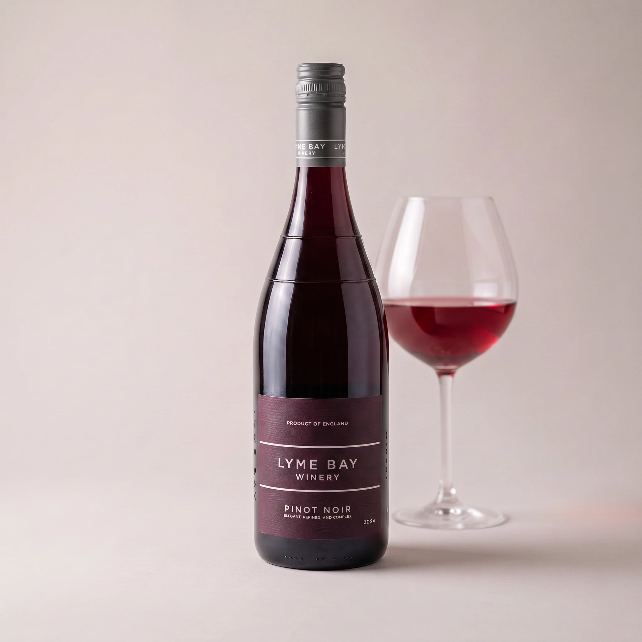 Lyme Bay Winery Pinot Noir bottle with a glass of red wine