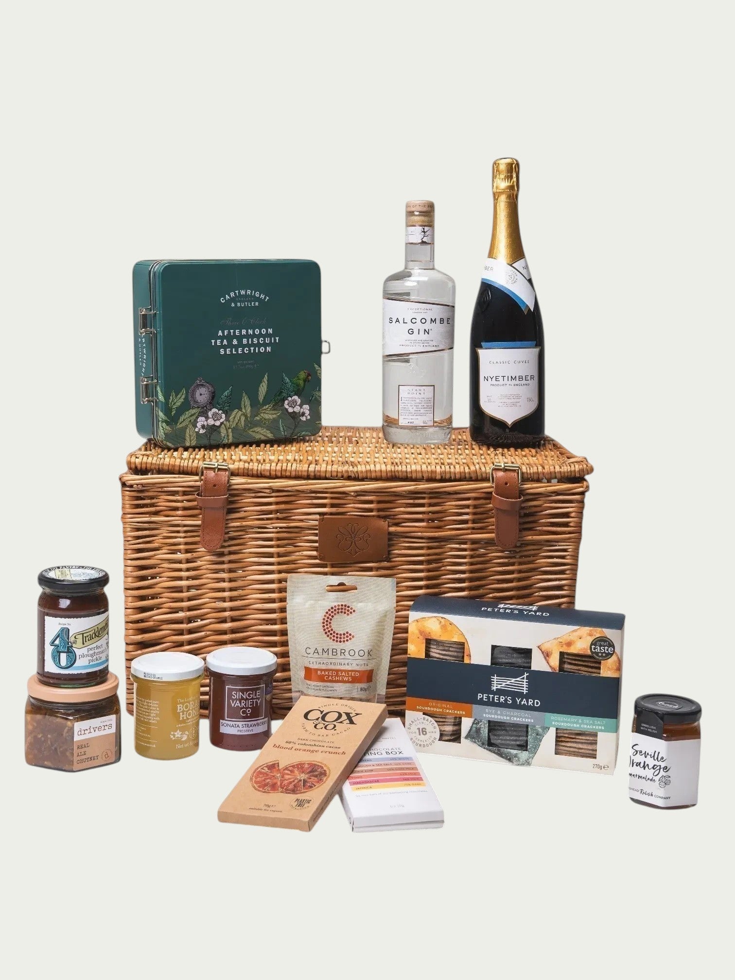 Made In England The English Celebration Hamper with sparkling wine, gin, crackers, biscuits, chocolate, preserves, and nuts.