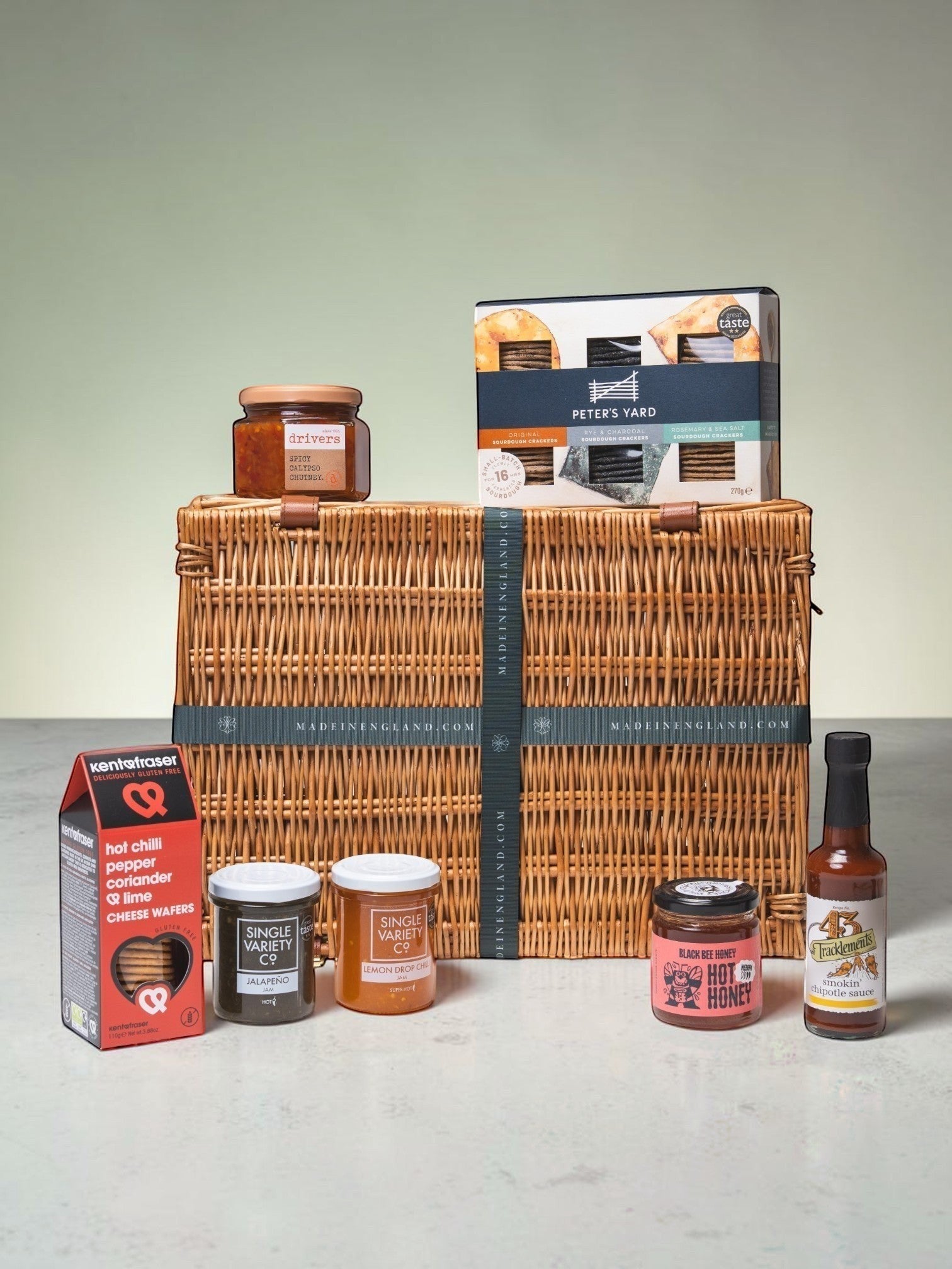 Made In England gourmet food hamper with crackers, chutneys, hot honey, and chipotle sauce.