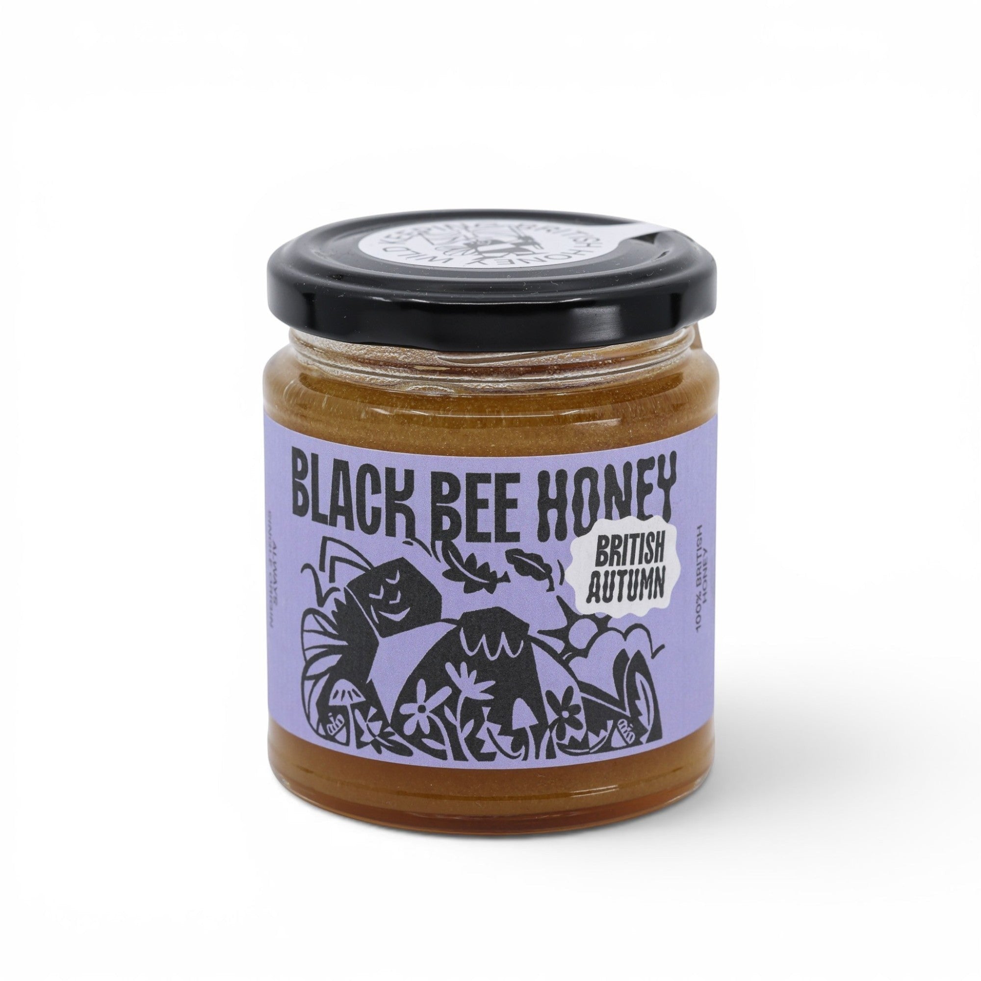 Made In England Black Bee Honey, unblended British heather honey with a thick texture and rich flavour, in a glass jar with a black lid.