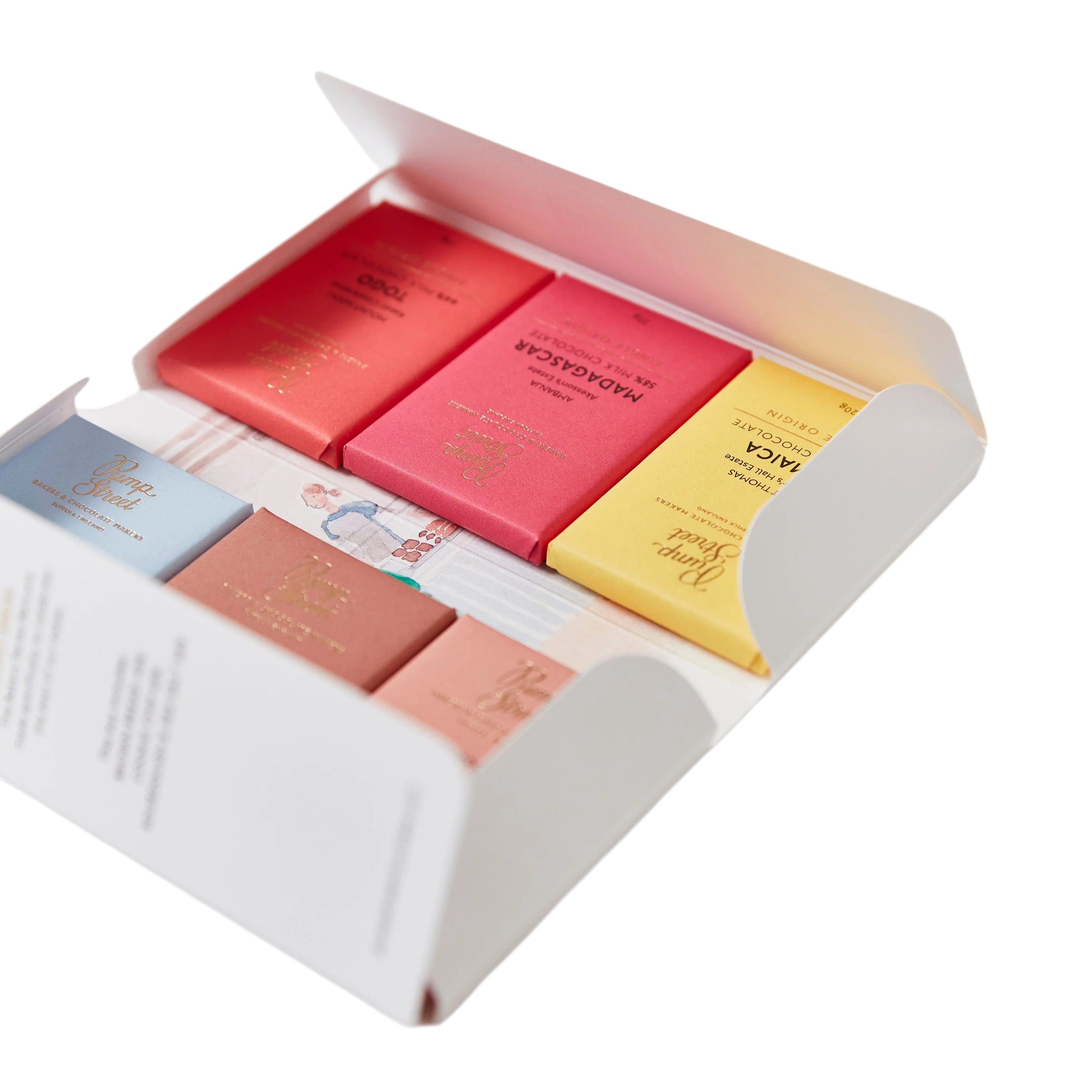 Made In England Pump Street tasting box with six mini chocolate bars in red, pink, yellow, blue, and brown wrappers.