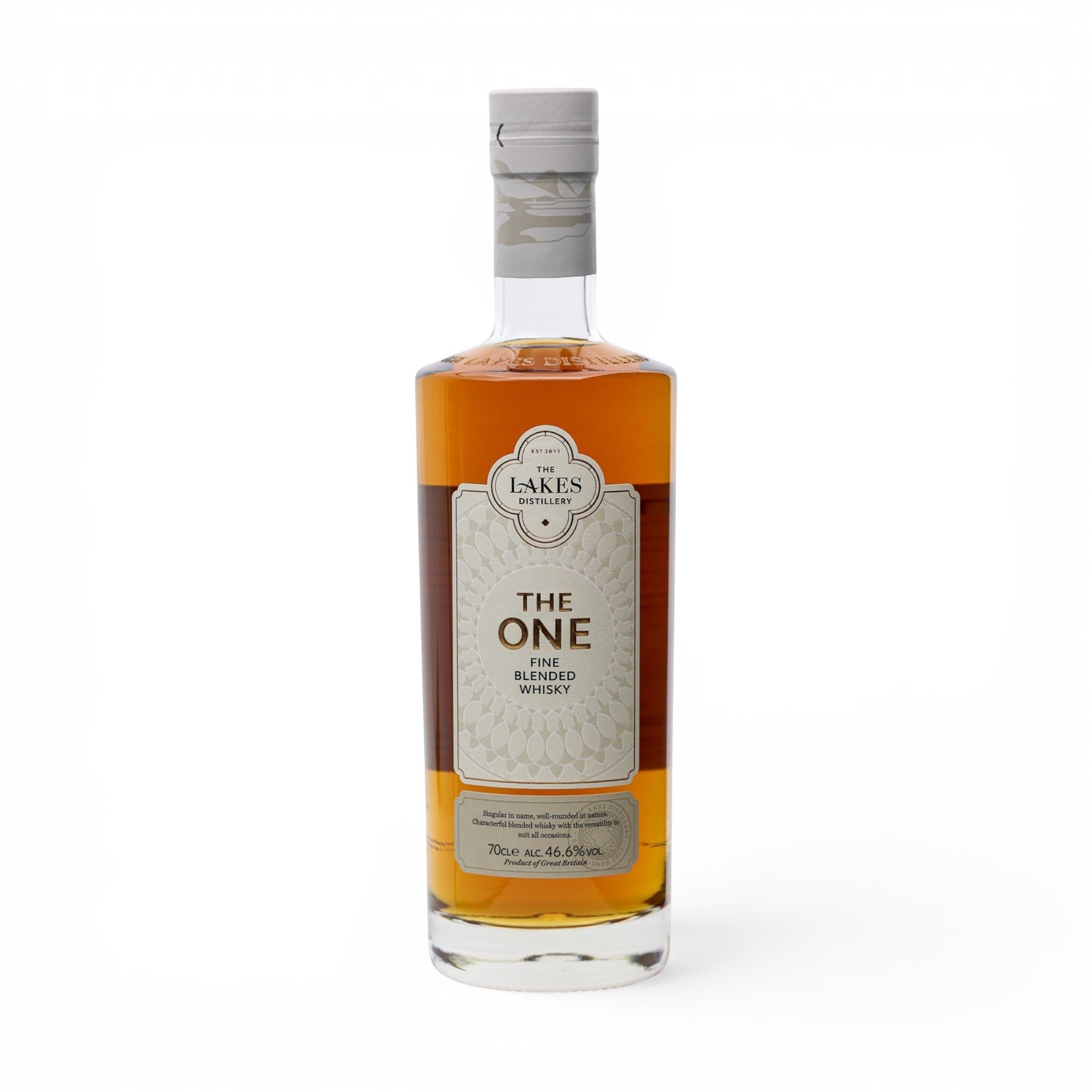 Made In England The One Fine Blended Whisky bottle with amber liquid and a light grey label featuring decorative patterns.