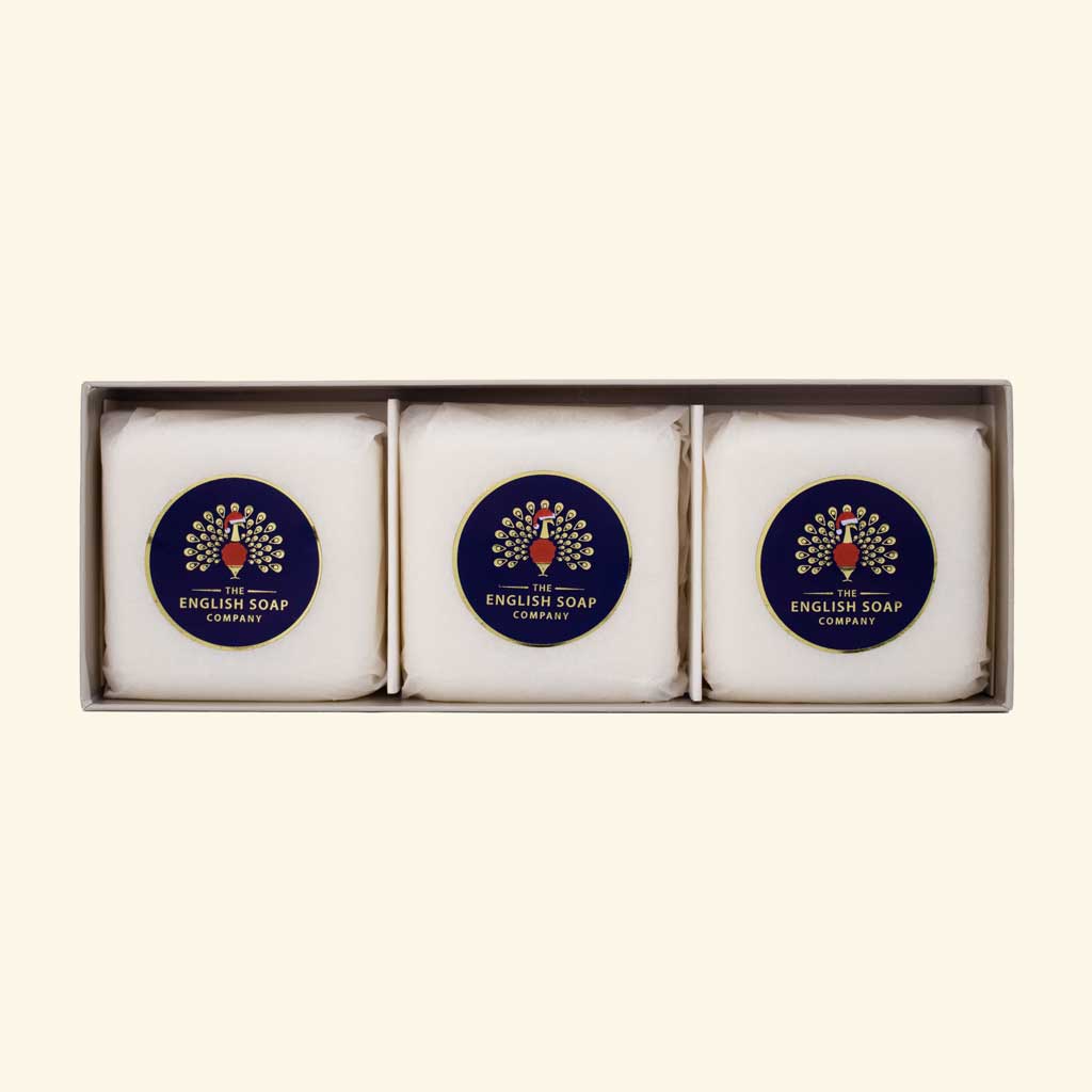 Three soap bars with a peacock emblem in the open gift box