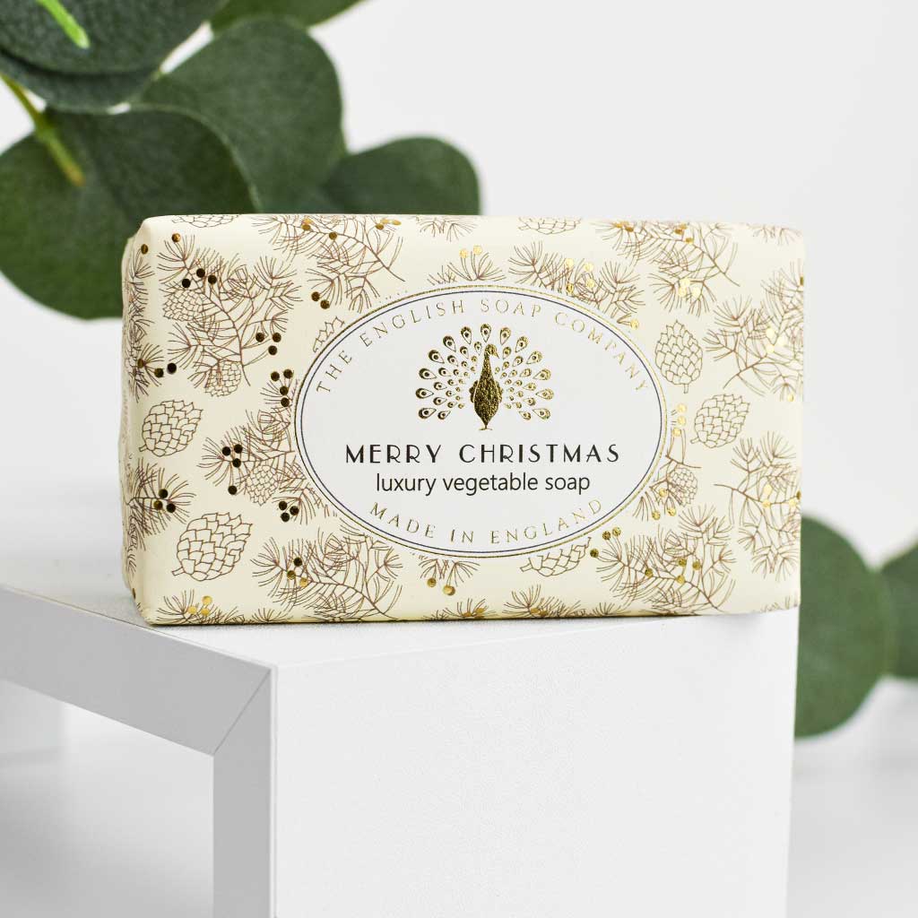 Merry Christmas soap bar on a white block with eucalyptus leaves