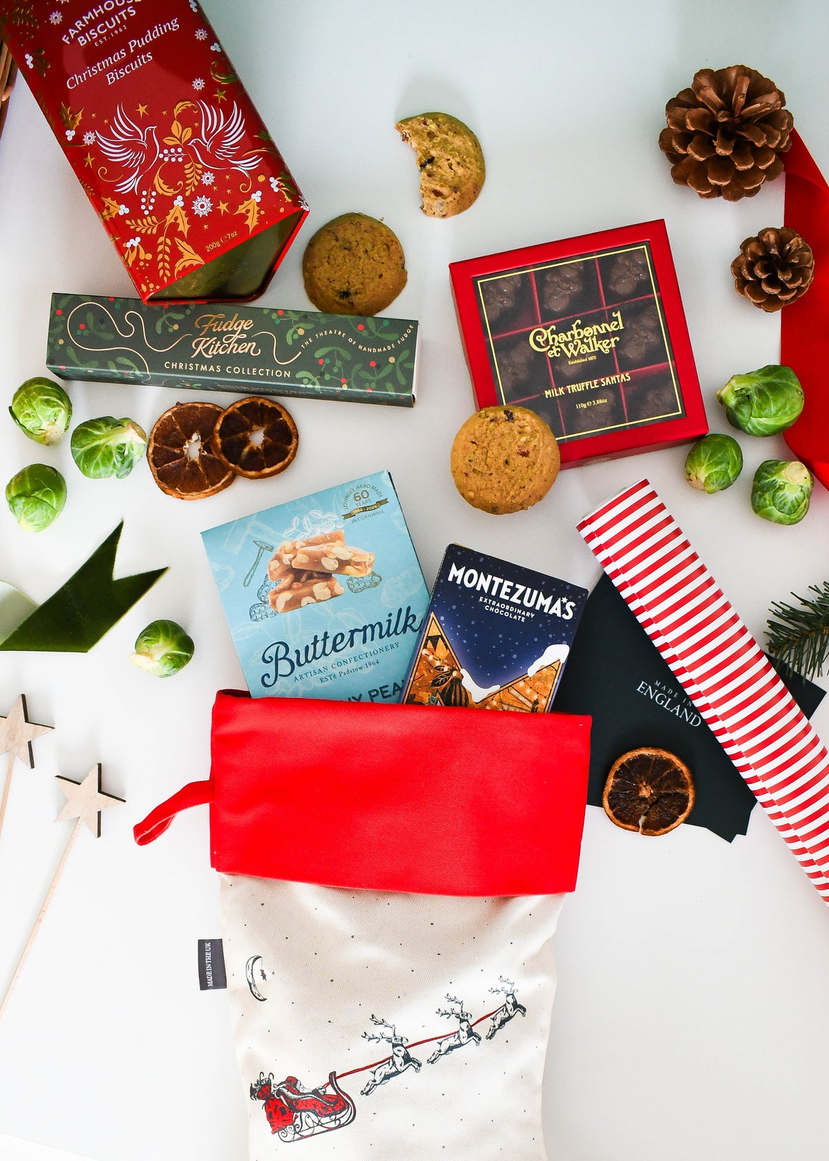 Overhead view of the pre-filled Christmas stocking with Charbonnel et Walker Santas, Fudge Kitchen fudge and Farmhouse Biscuits