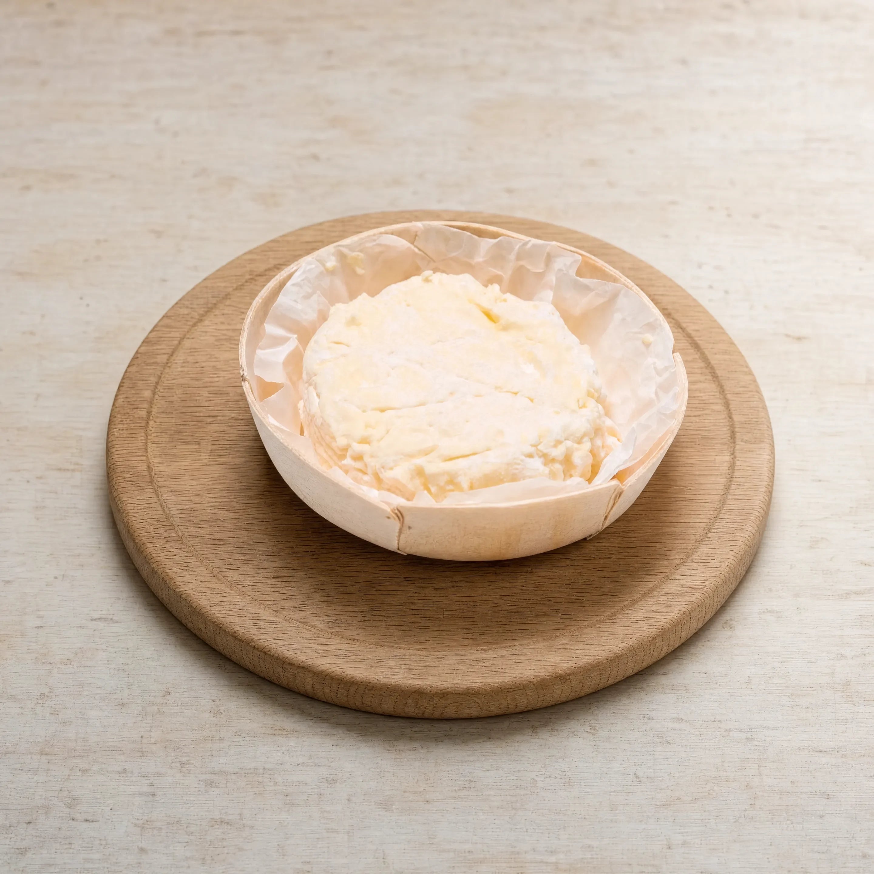 St Jude soft cheese on a board, English cheesemonger counter