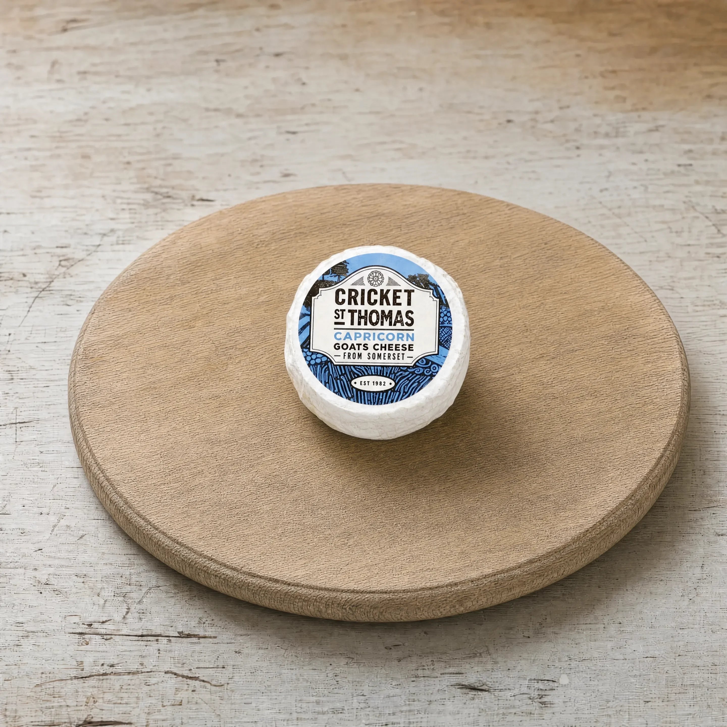Capricorn goats' cheese on an oak board, English cheesemonger counter