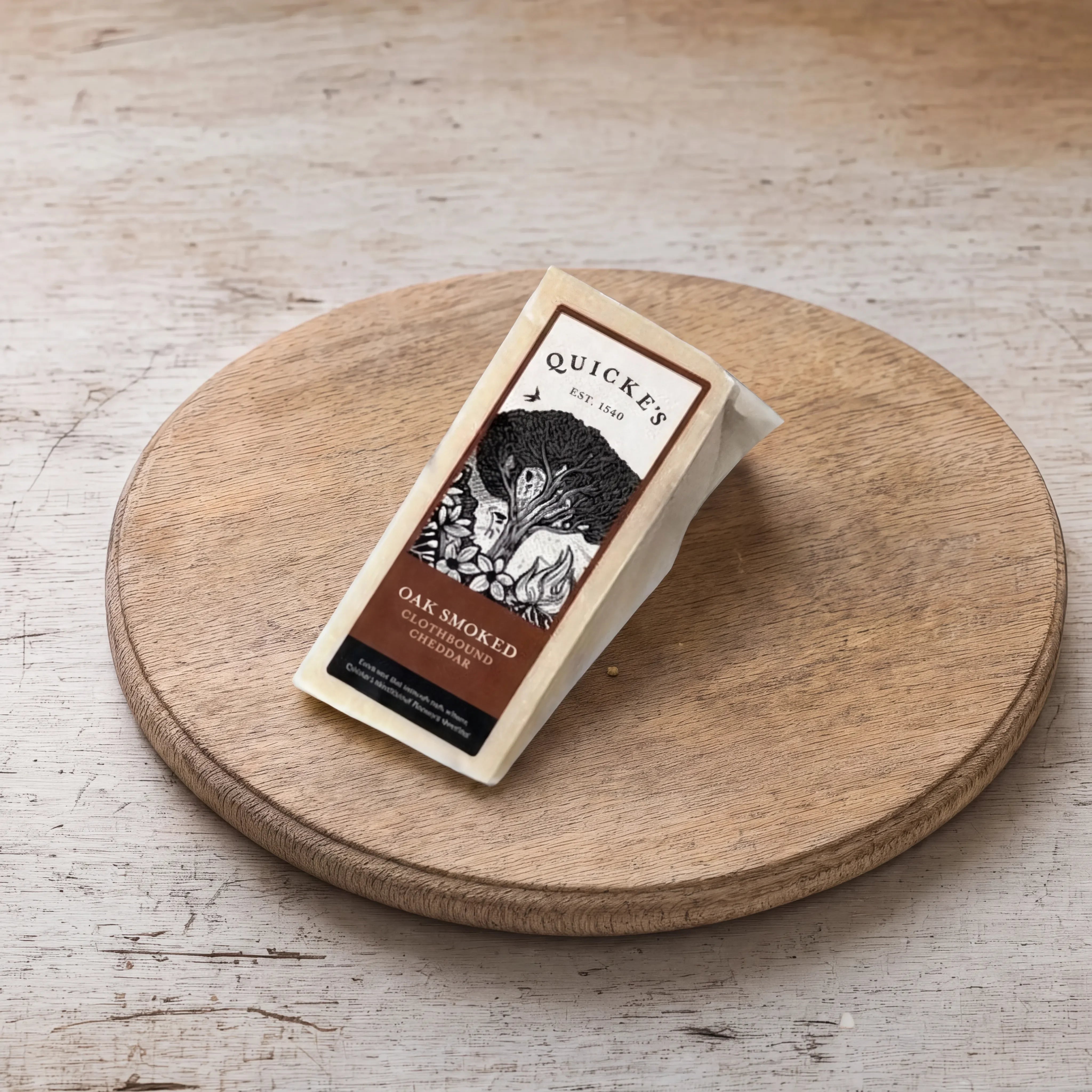 Quicke's Oak Smoked Clothbound Cheddar on an oak board