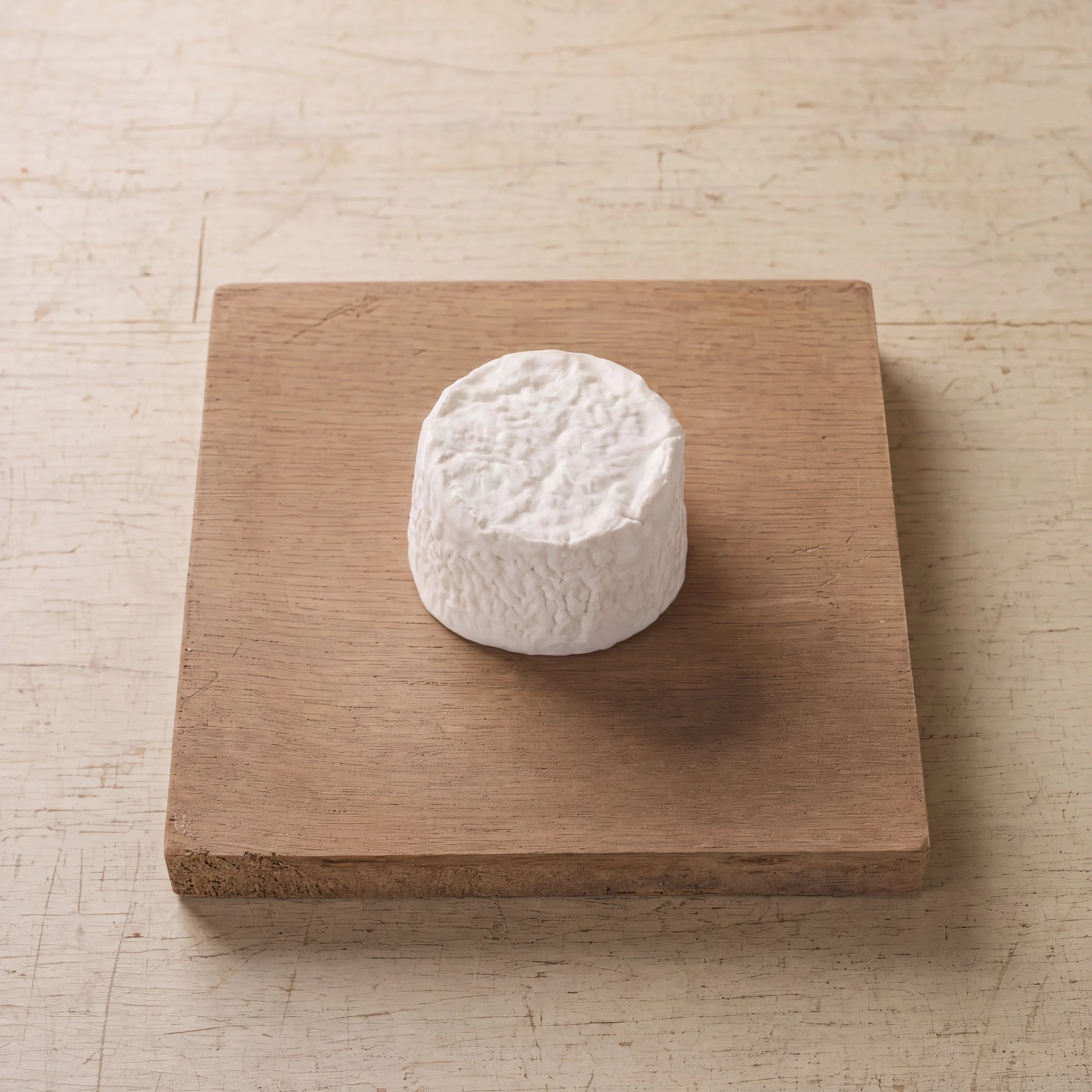 Bix soft cheese on an oak board, English cheesemonger counter