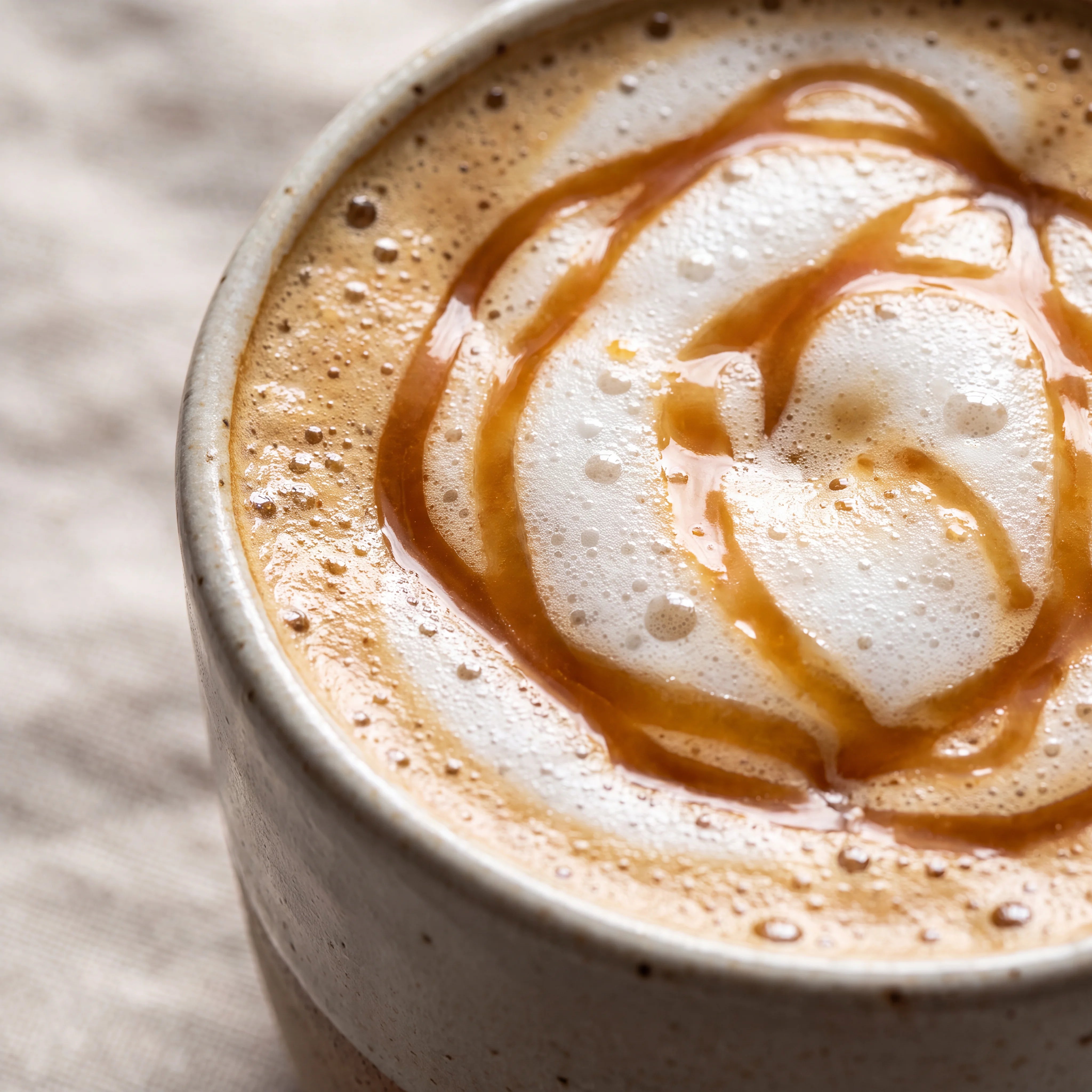 Creamy caramel latte coffee with a caramel drizzle