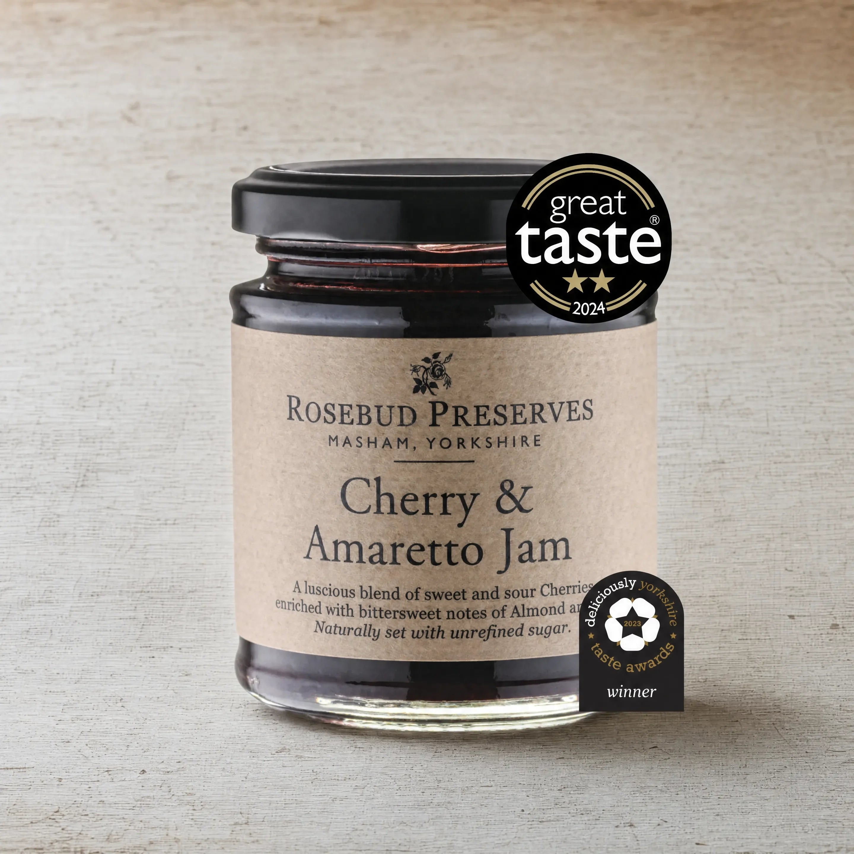 Rosebud Preserves Cherry and Amaretto Jam jar on an English cheesemonger counter