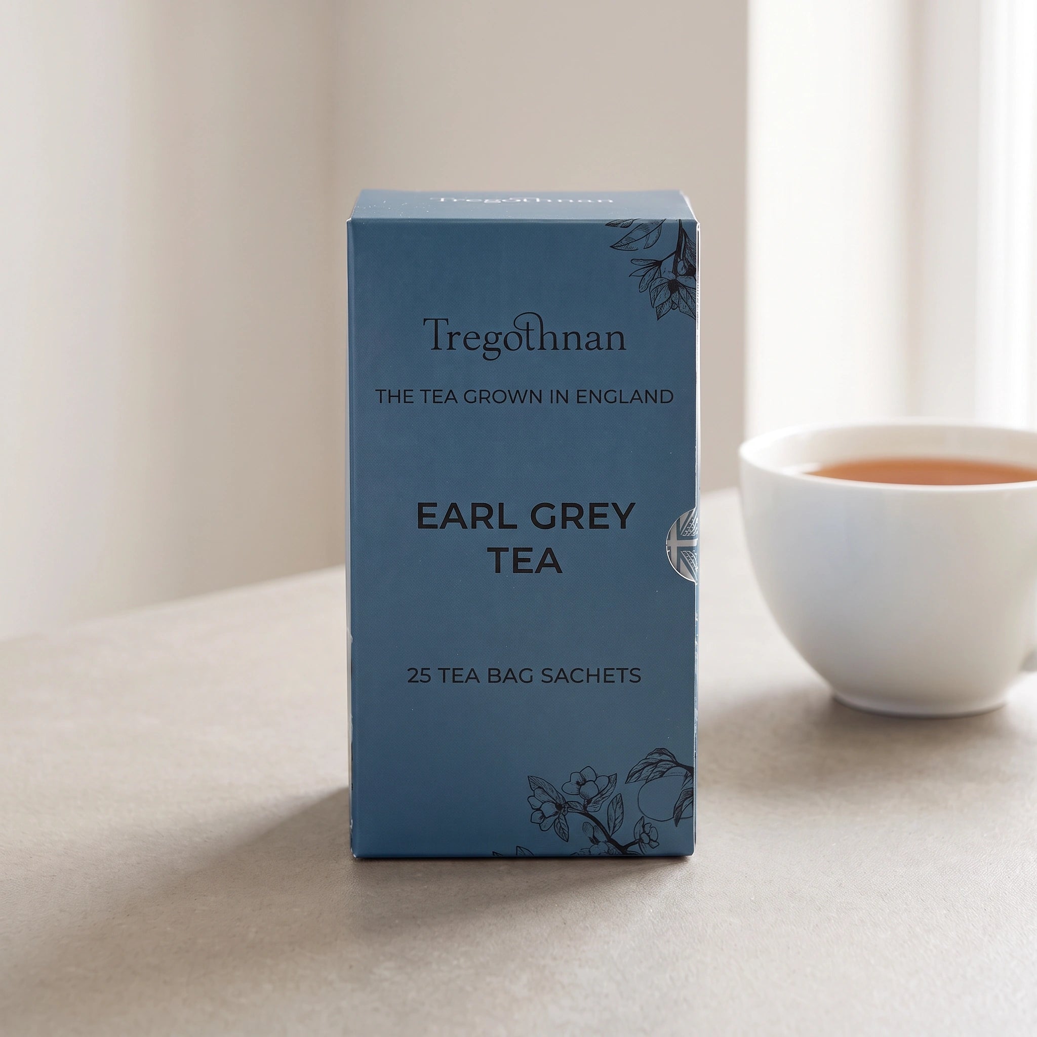 Tregothnan Earl Grey tea sachet box front-on with a cup of amber tea