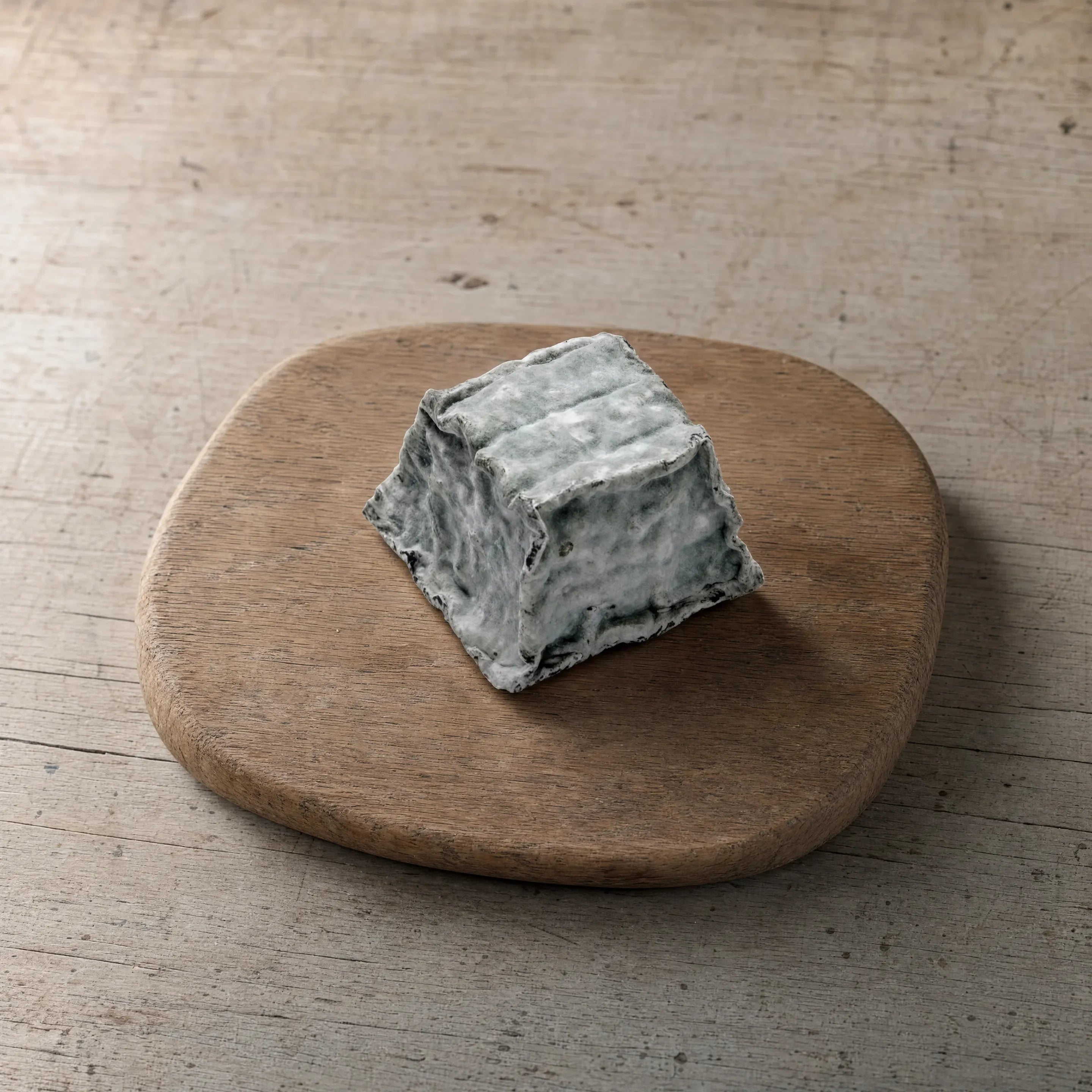 Pavé Cobble ashed cheese on a cheese board, English cheesemonger counter