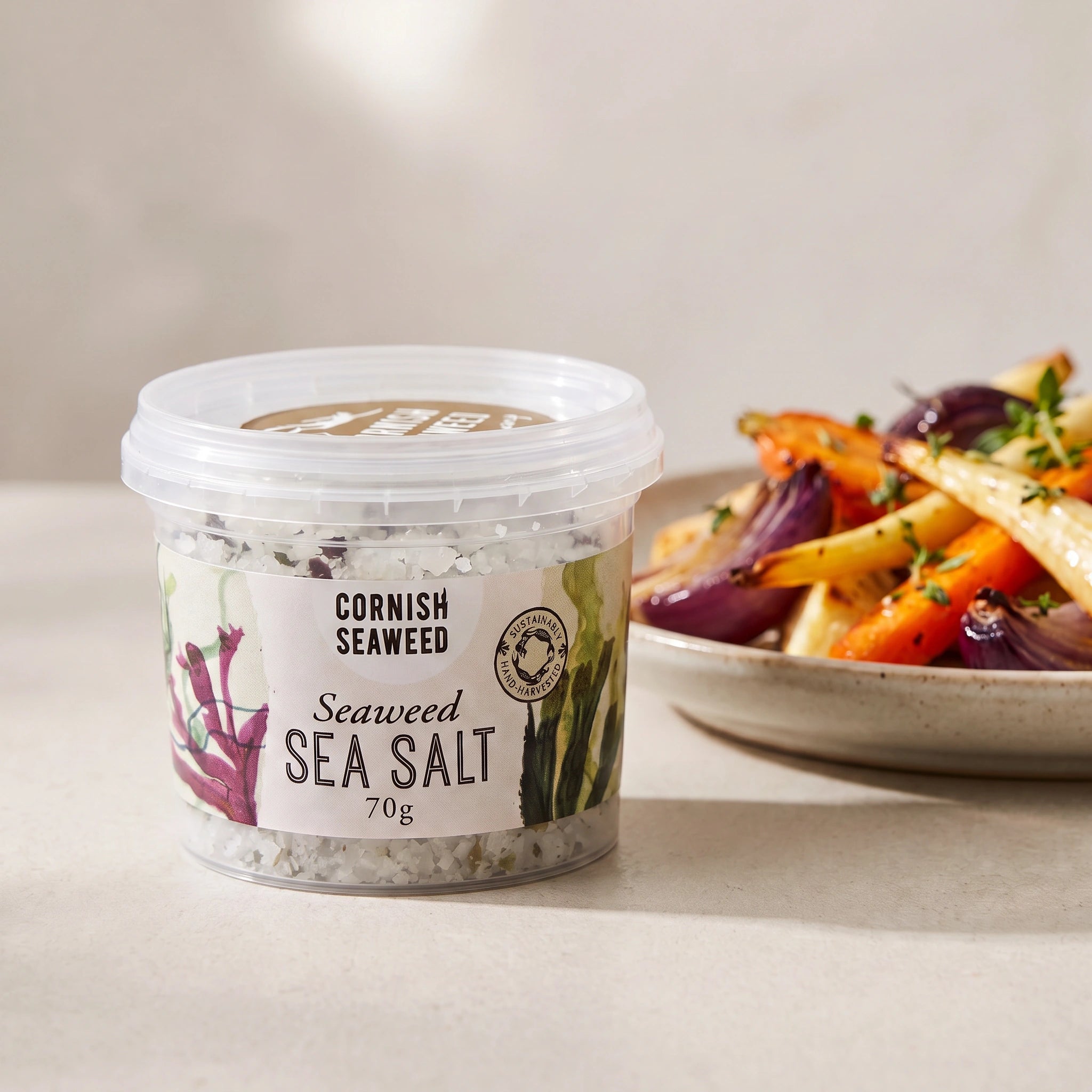 Cornish Seaweed Sea Salt tub with roasted vegetables
