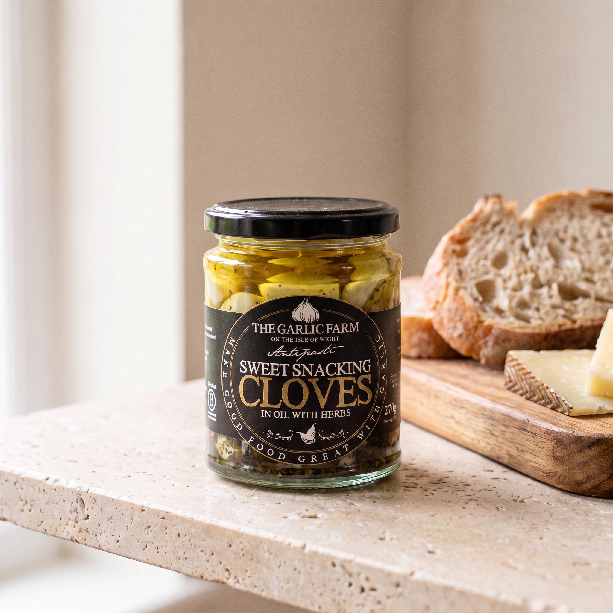 The Garlic Farm Sweet Snacking Cloves jar with cheese and bread