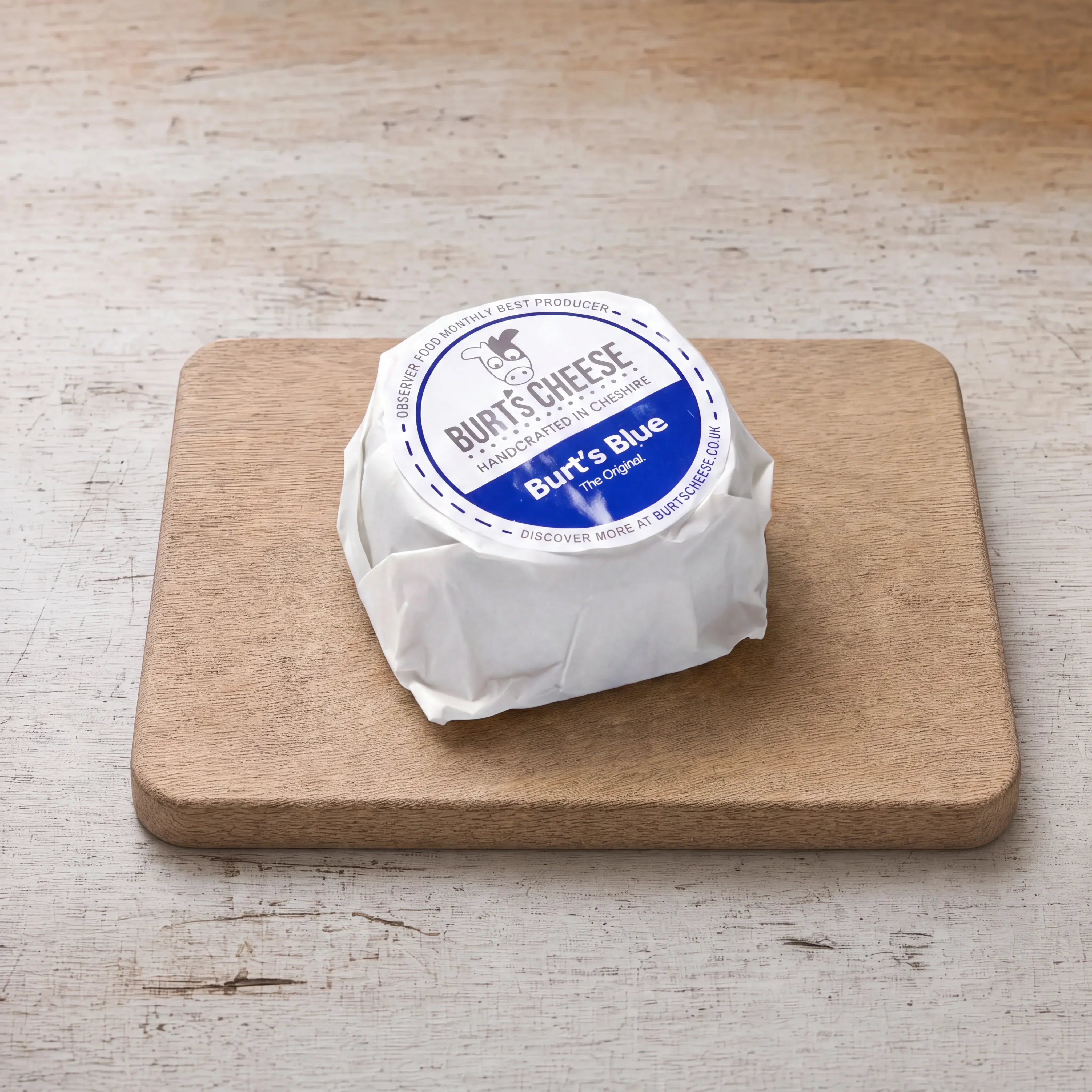 Burt's Blue cheese on an oak board, English cheesemonger counter