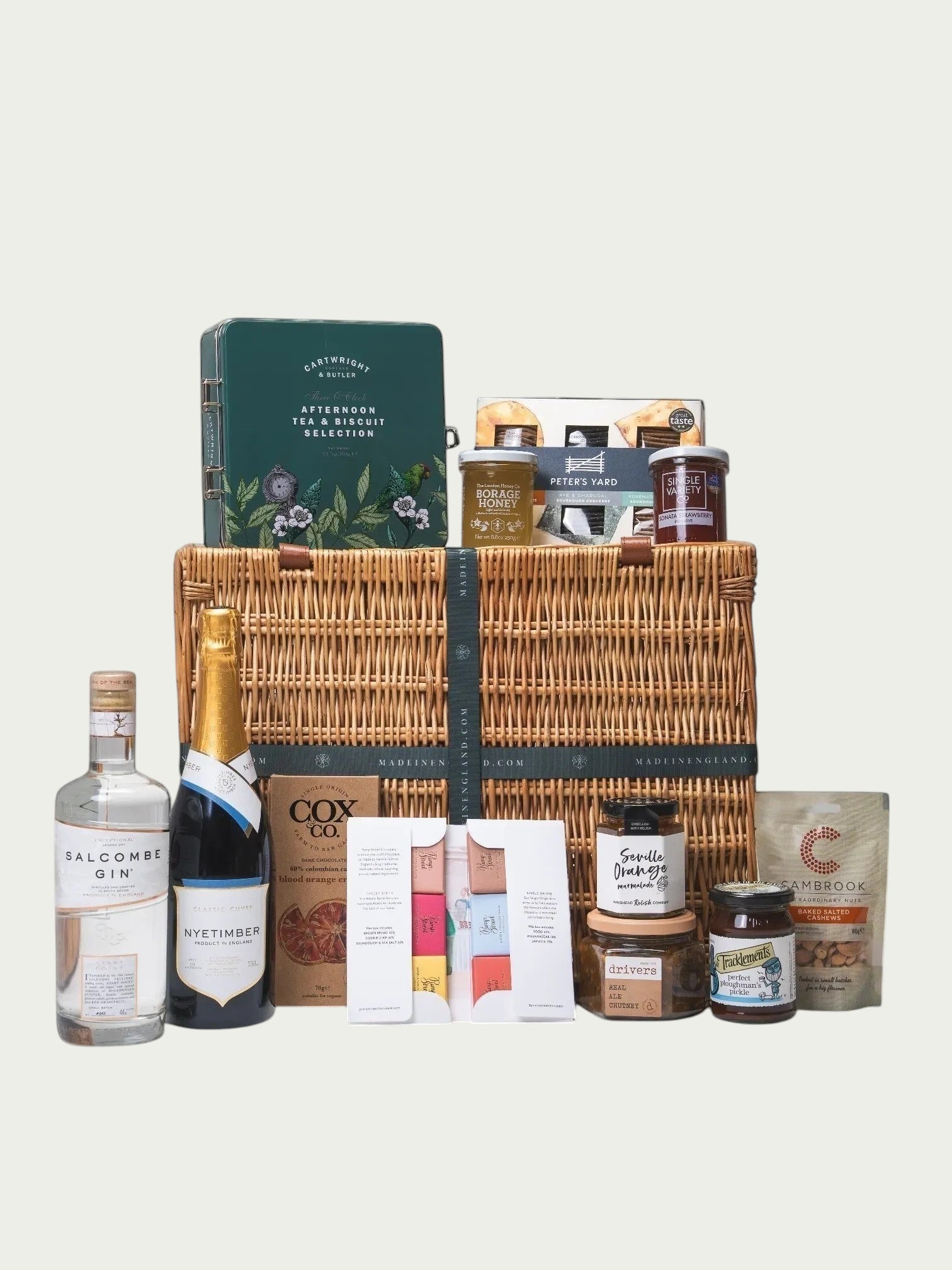 Made In England English Celebration Hamper with sparkling wine, gin, tea, biscuits, crackers, preserves, chutney, honey, and nuts.