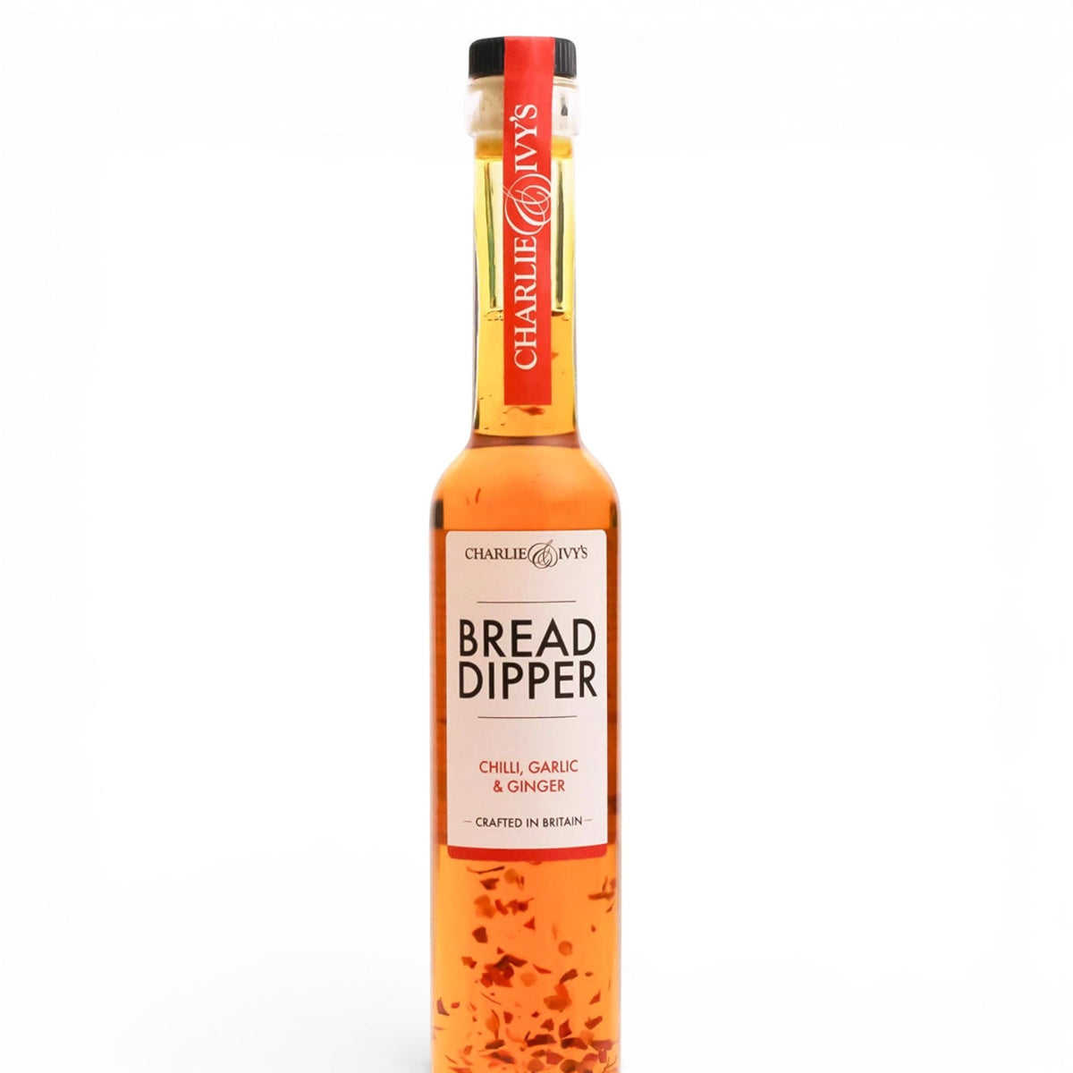 Made In England Charlie & Ivy's Chilli, Garlic & Ginger Bread Dipper in a clear glass bottle with red label. Infused with chilli flakes.