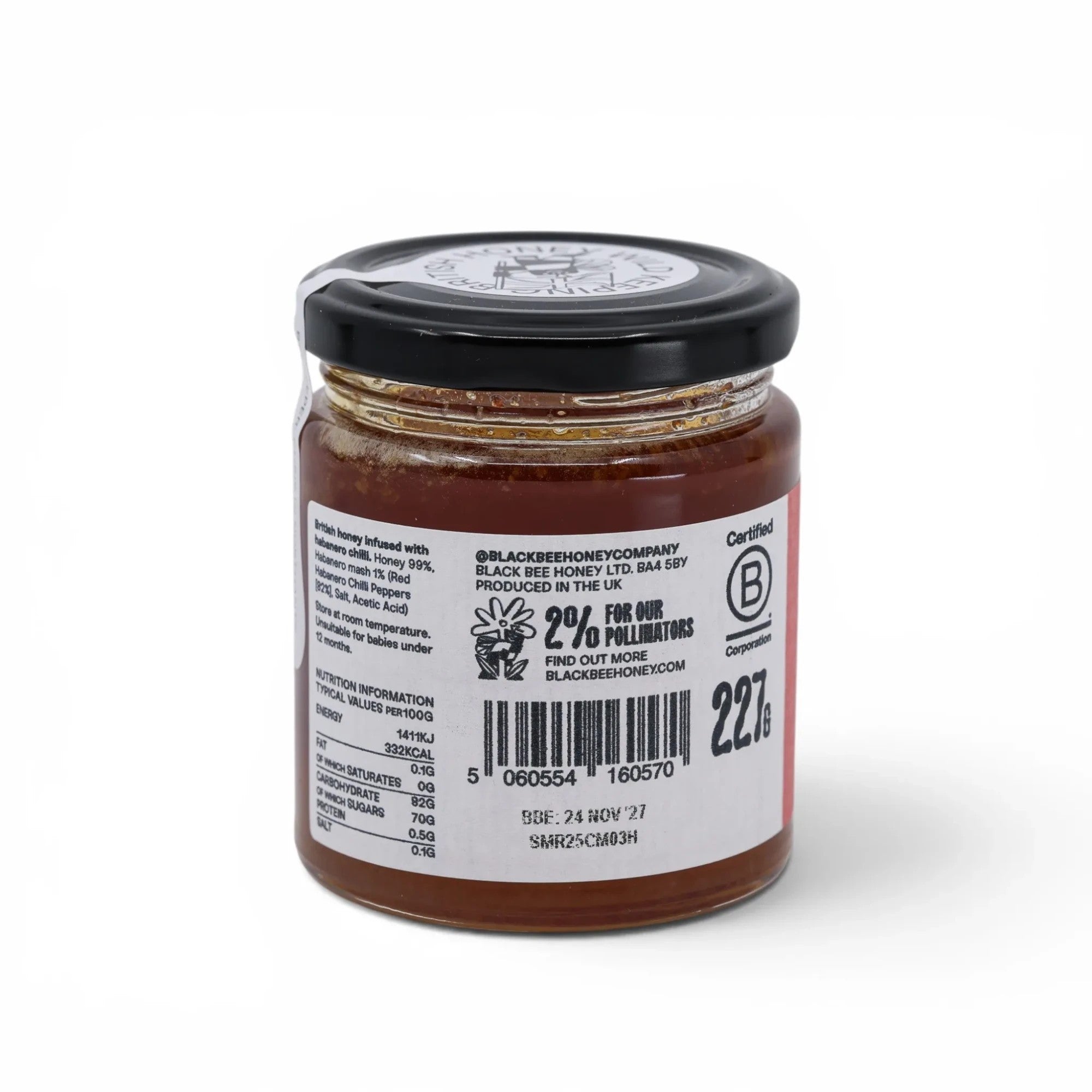 Made In England Black Bee Infused Chilli Honey in a glass jar with a black lid. The label details ingredients and nutrition information.