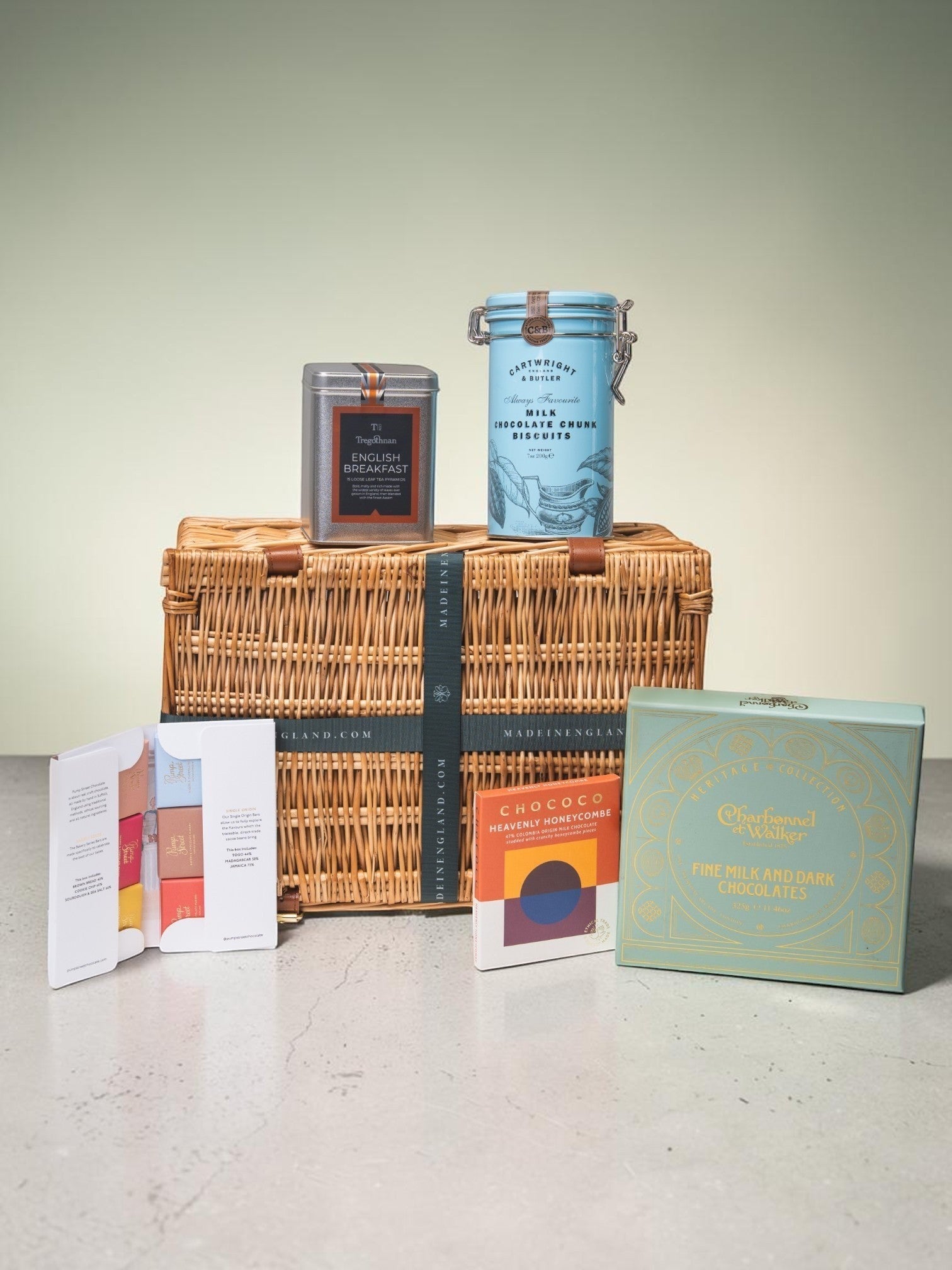 Made In England Artisan Chocolate and Tea Gift Hamper in woven basket with assorted chocolates and English Breakfast Tea.
